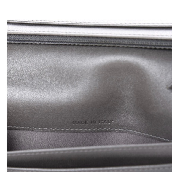 This is an authentic CHANEL Lambskin Camellia Embossed Yen Wallet in Black. - Picture 7 of 8